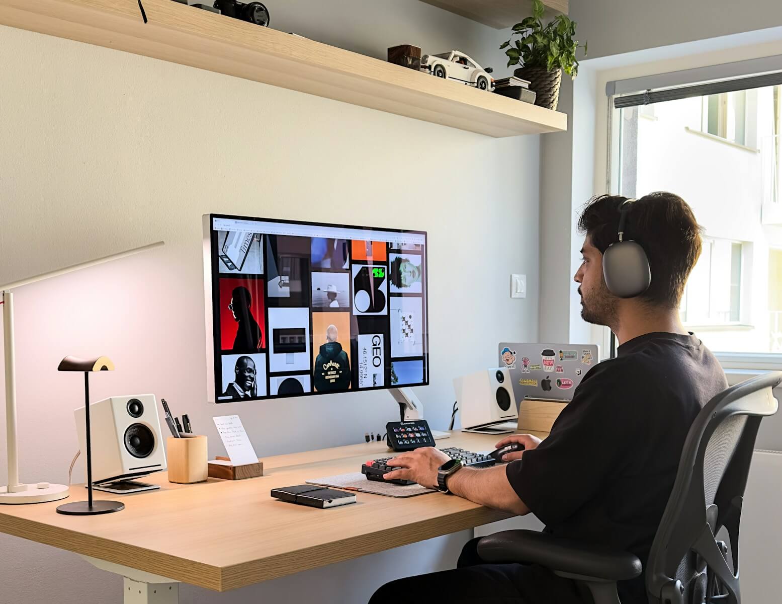 a man sitting at a desk with headphones on